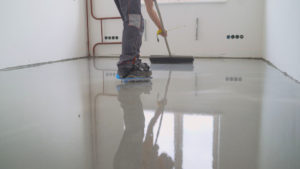 A worker install a garage floor coating