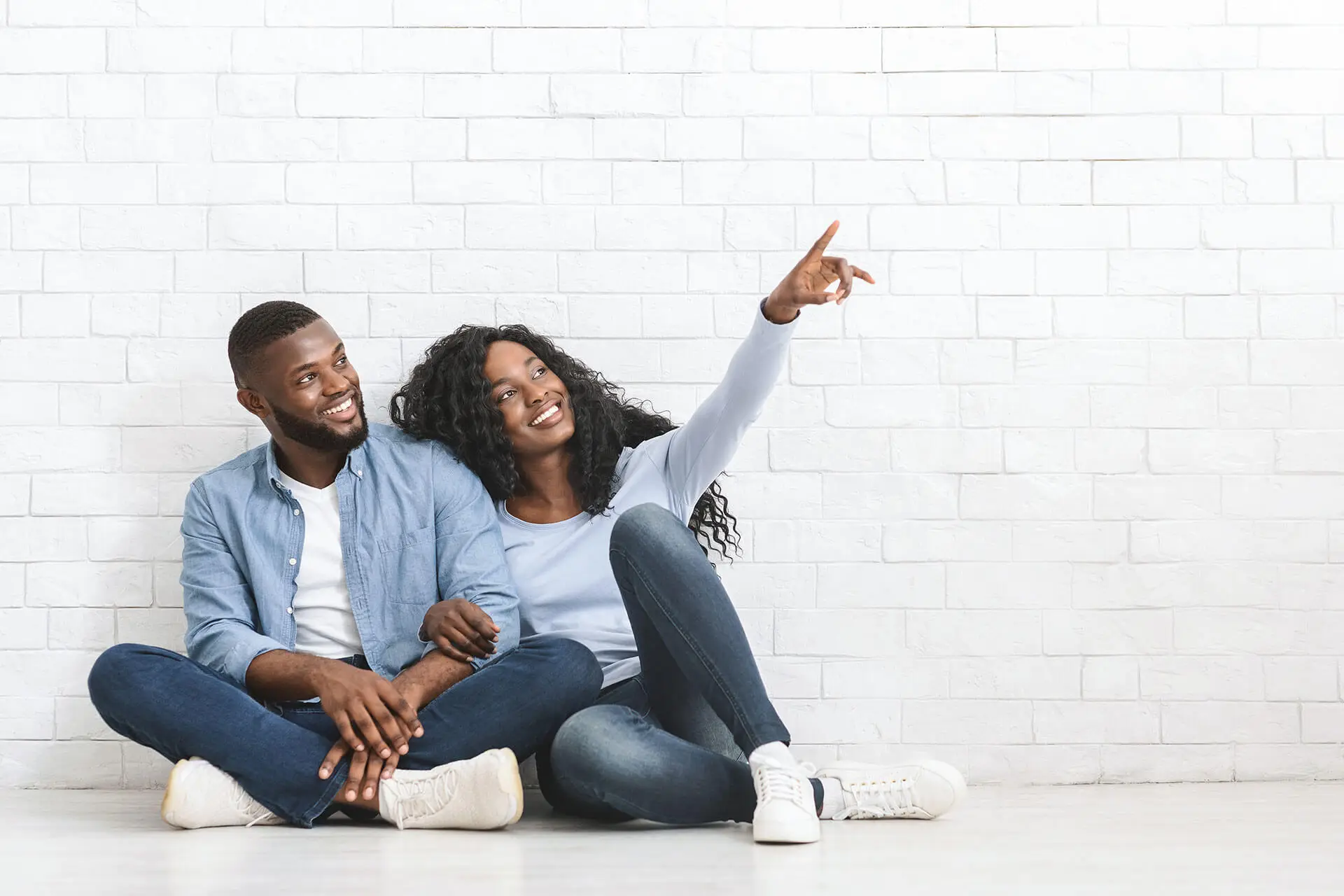 Couple sitting and pointing